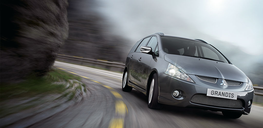 Grandis driving down road